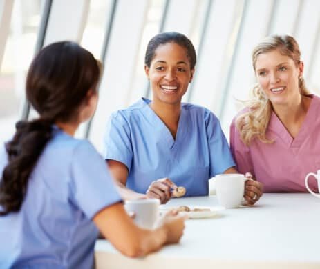 Healthcare trainees talking together between sessions