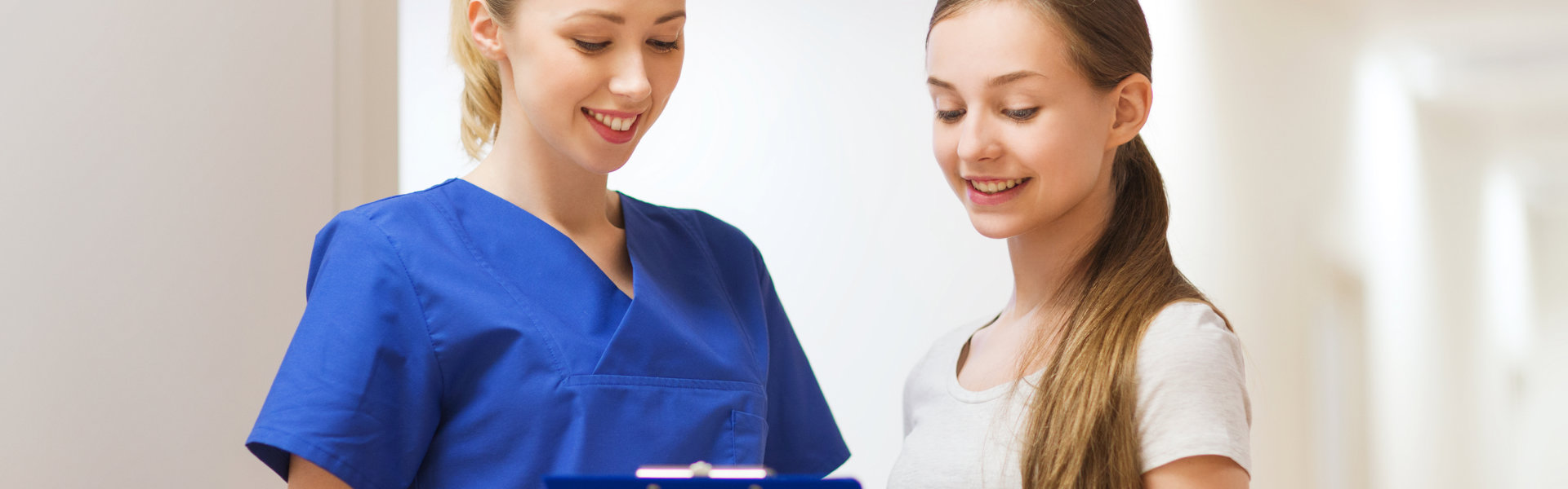 nurse and woman looking at the medical records